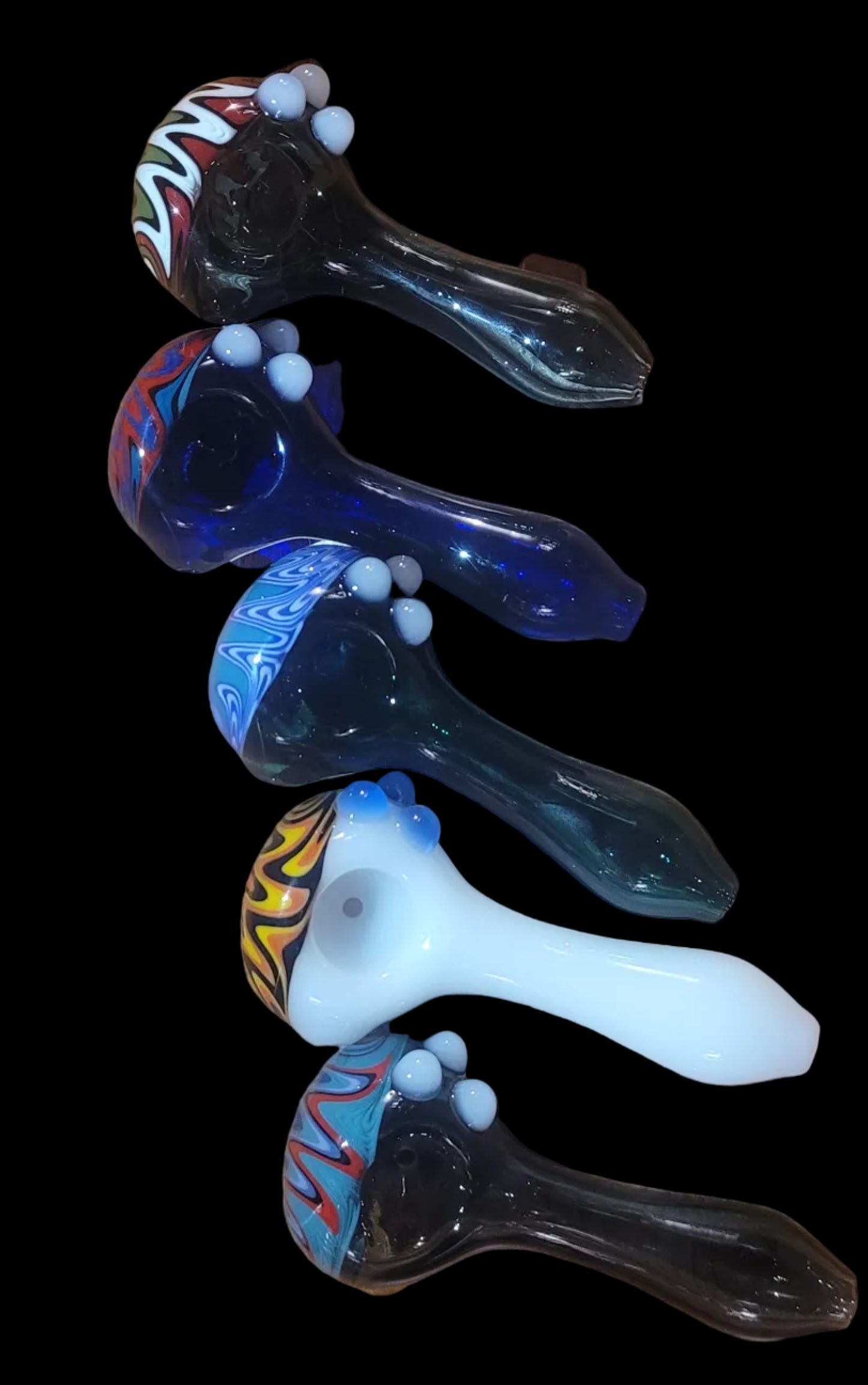Set of colorful glass smoking pipes on a black background